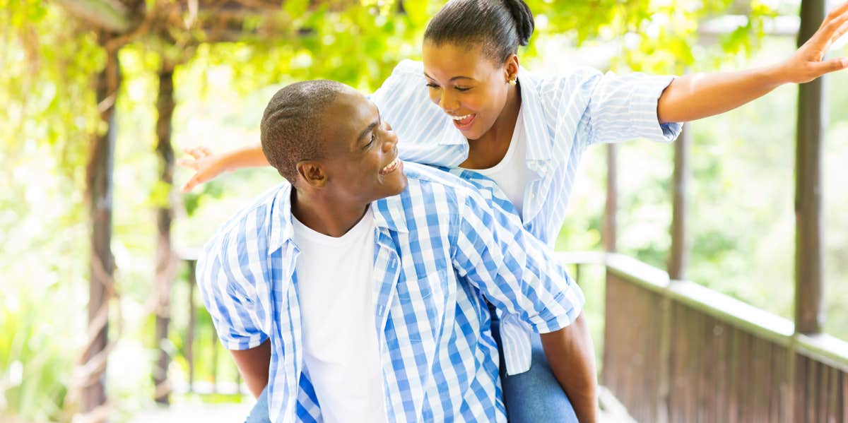 couple giving piggy back ride