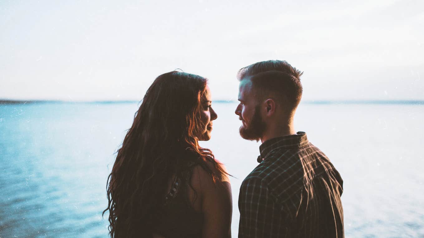 Two people talking by water 