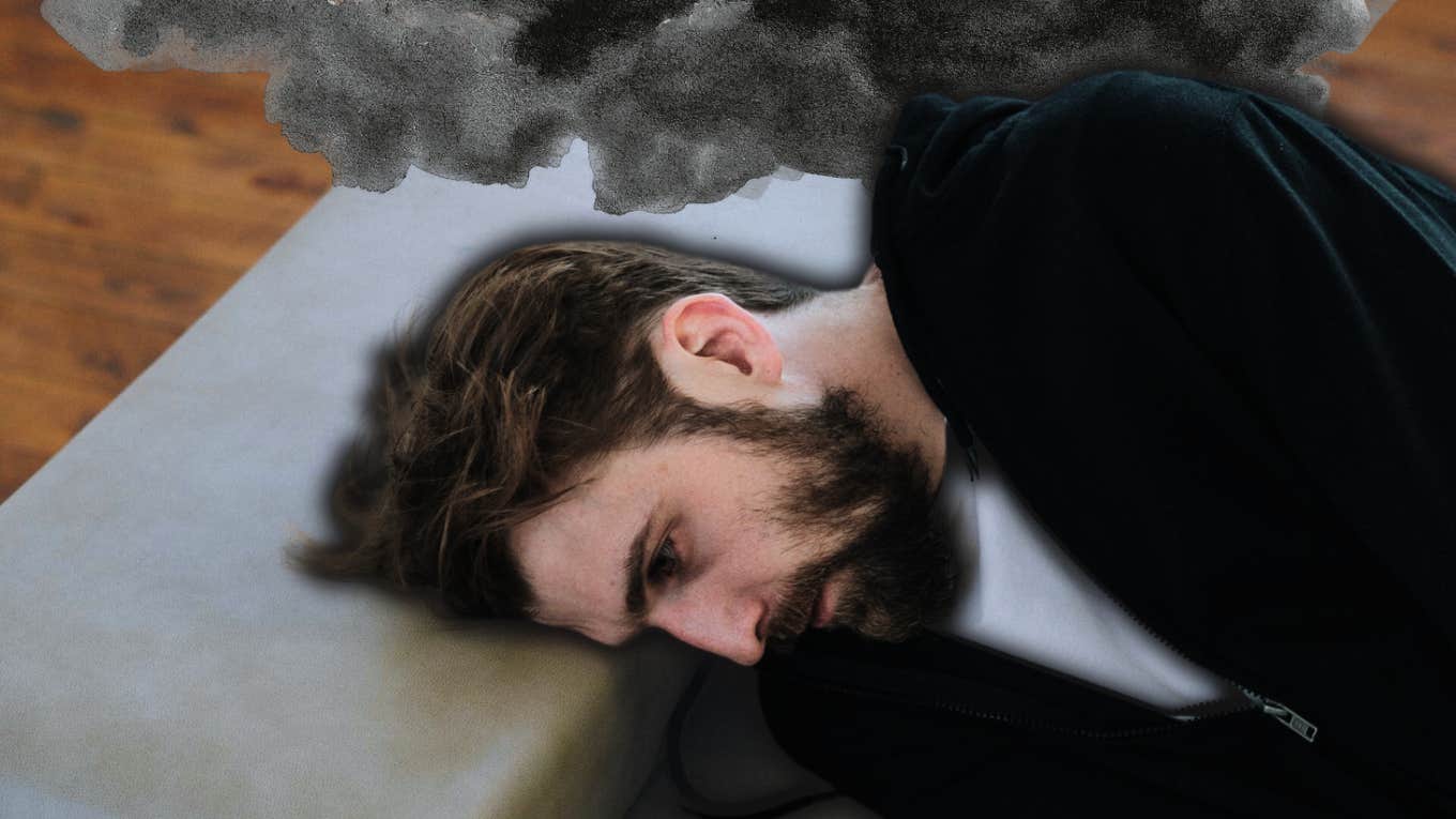 Depressed man laying on couch, zoning out 