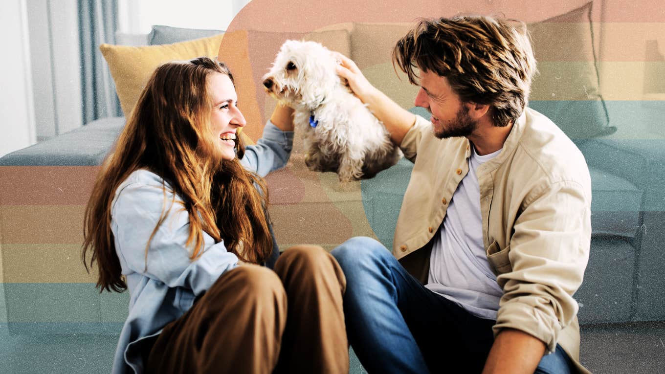 Couple chatting while petting their dog 