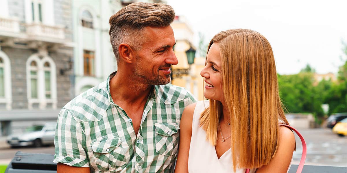 man and woman smiling at eachother