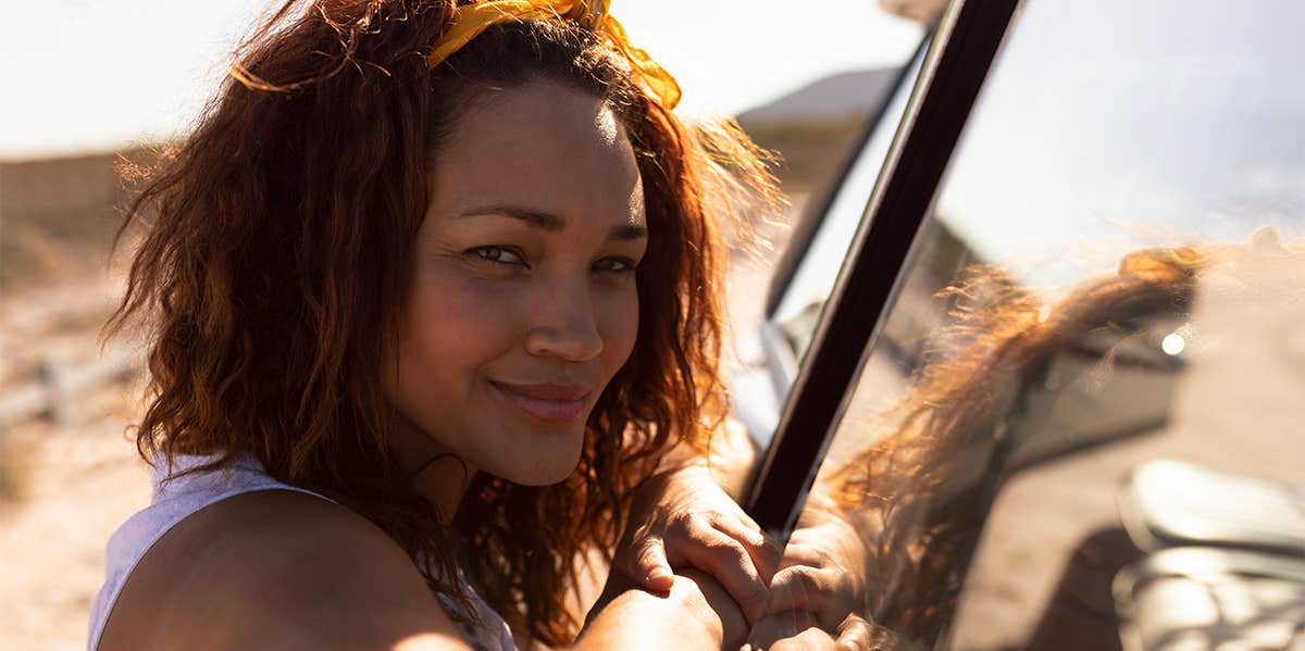 woman standing near car in desert