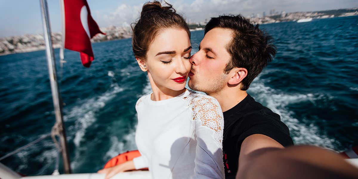 man kissing woman on boat