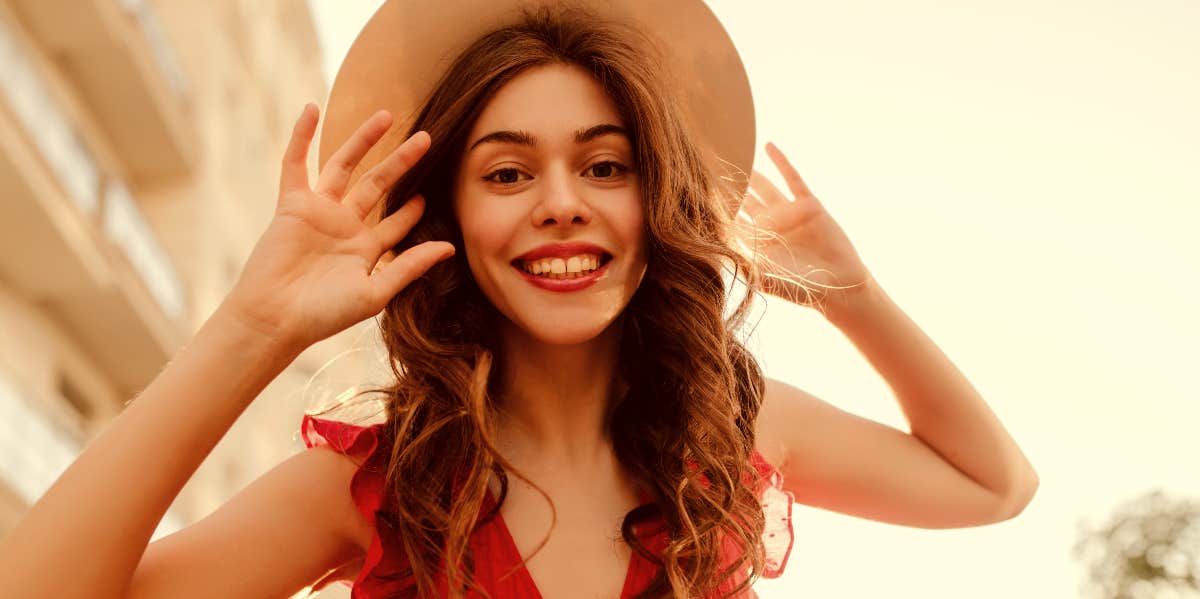 Charismatic woman with hat outdoors