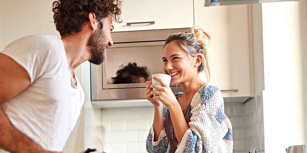 Relationships full of laughter man making his wife laugh in the kitchen