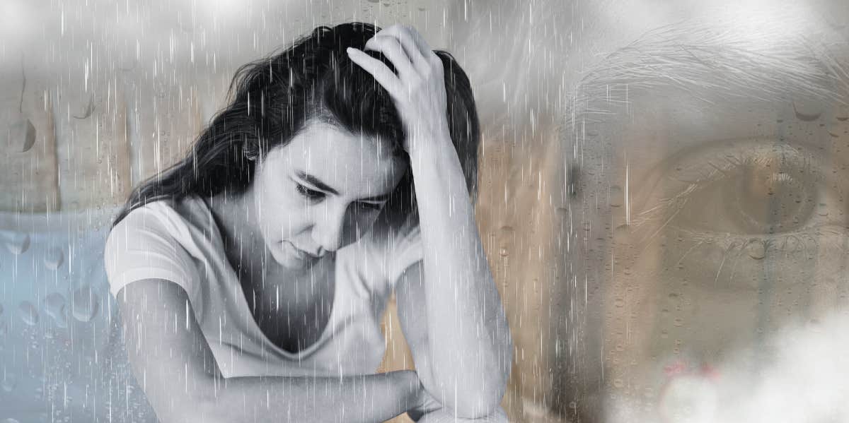 Woman feeling sad sitting in her bed