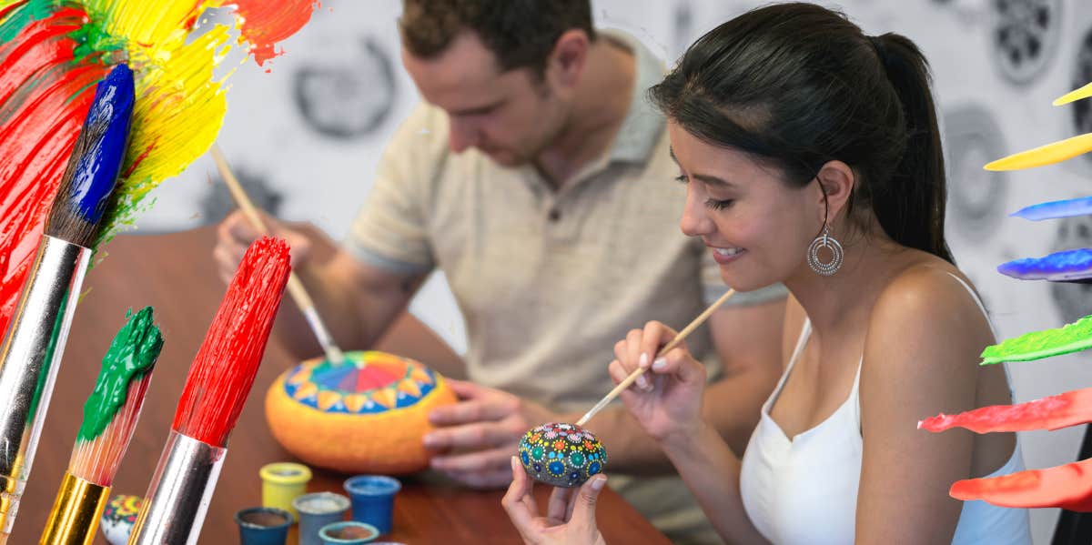 Happy couple painting pottery