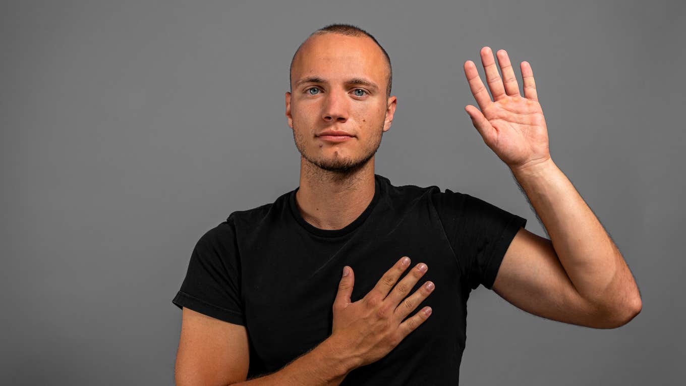 man swearing to tell the truth with hand on heart