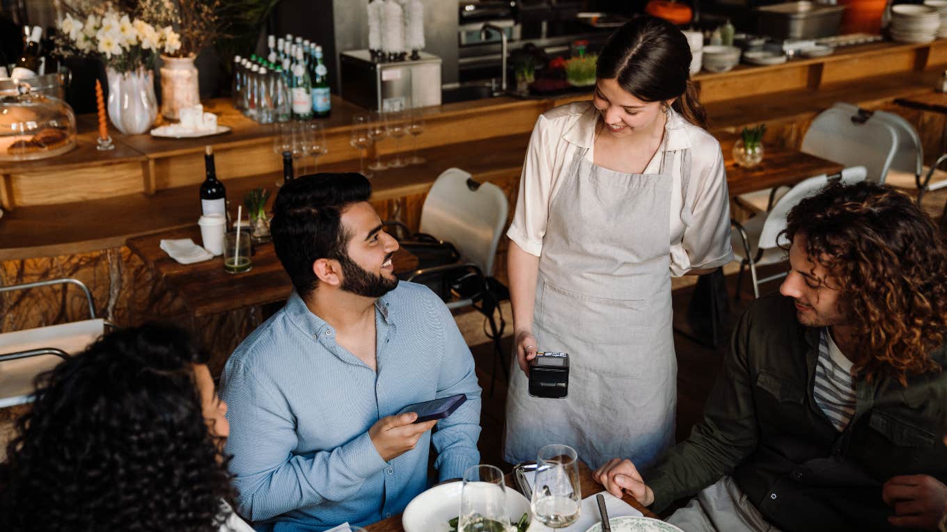 restaurant patrons paying food bill