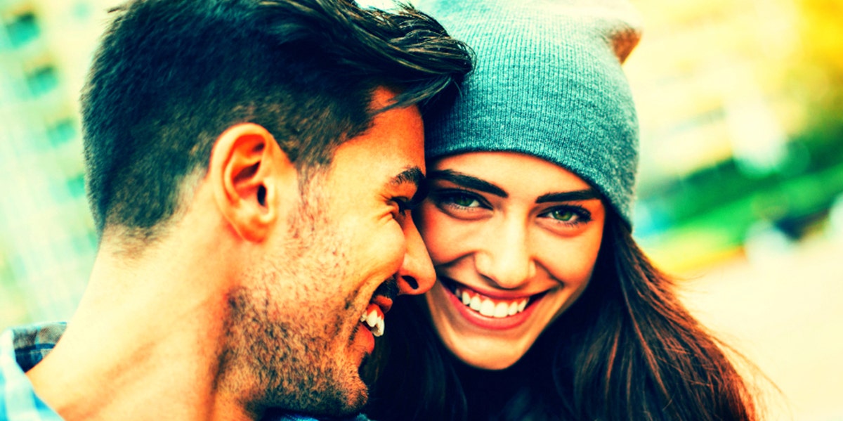 man and woman smiling and pressing cheeks together