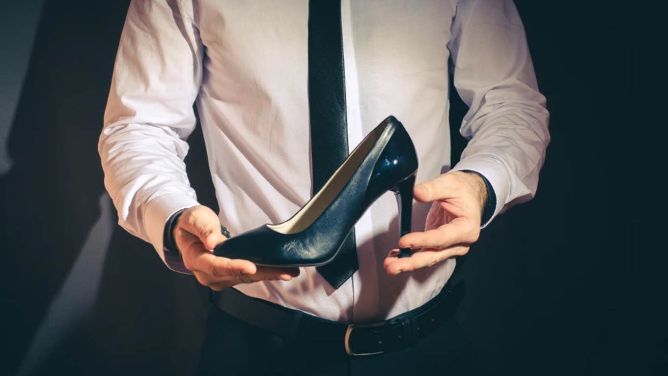 Male Robotics Engineer Wears Heels To Feel Confident businessman holding a high heel