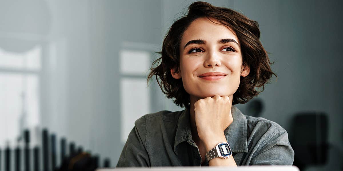 Woman with short dark hair looking proud