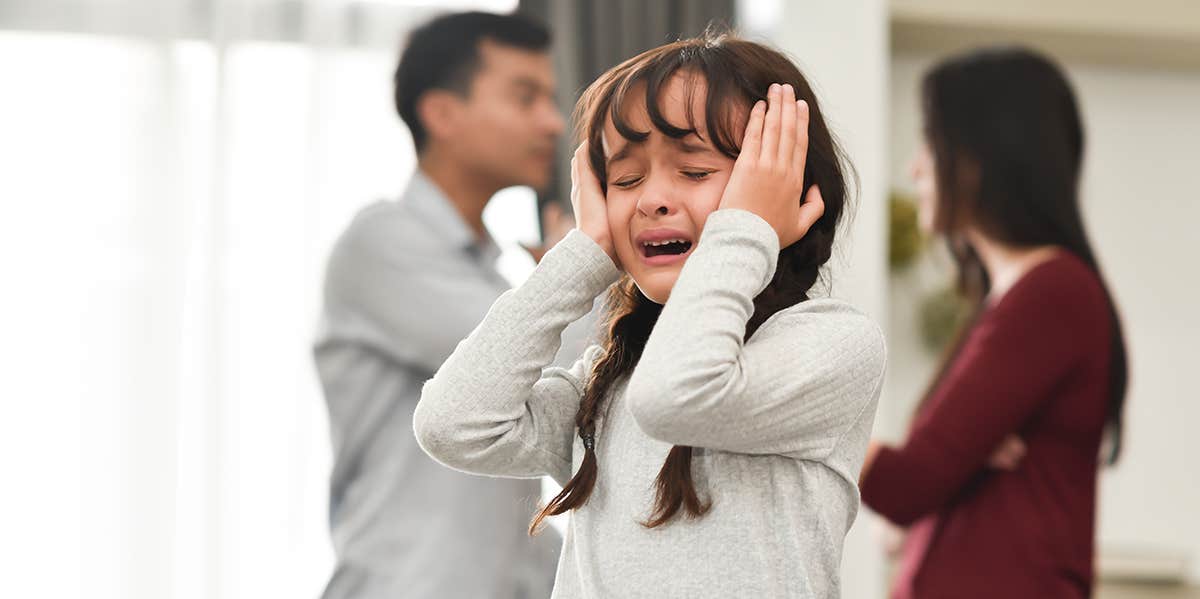 child covering her ears