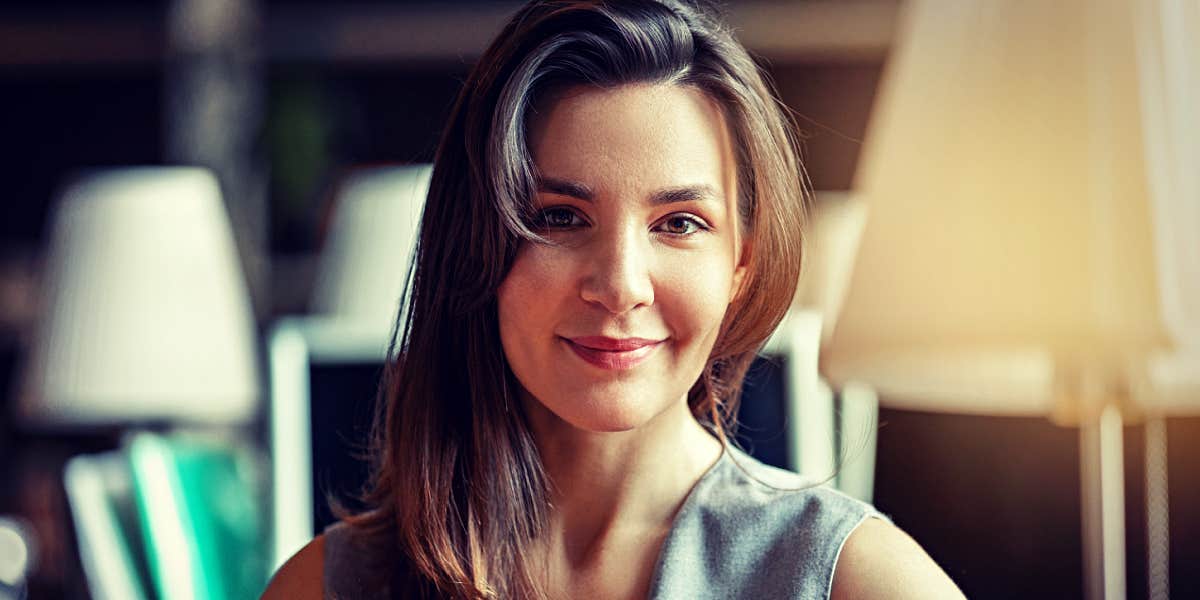 woman in library, smiling serenely