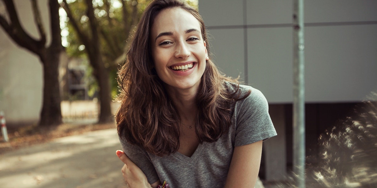 smiling woman in gray t-shirt