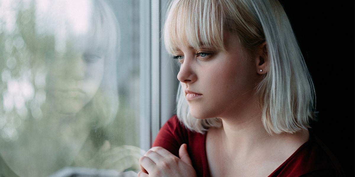 woman looking out window