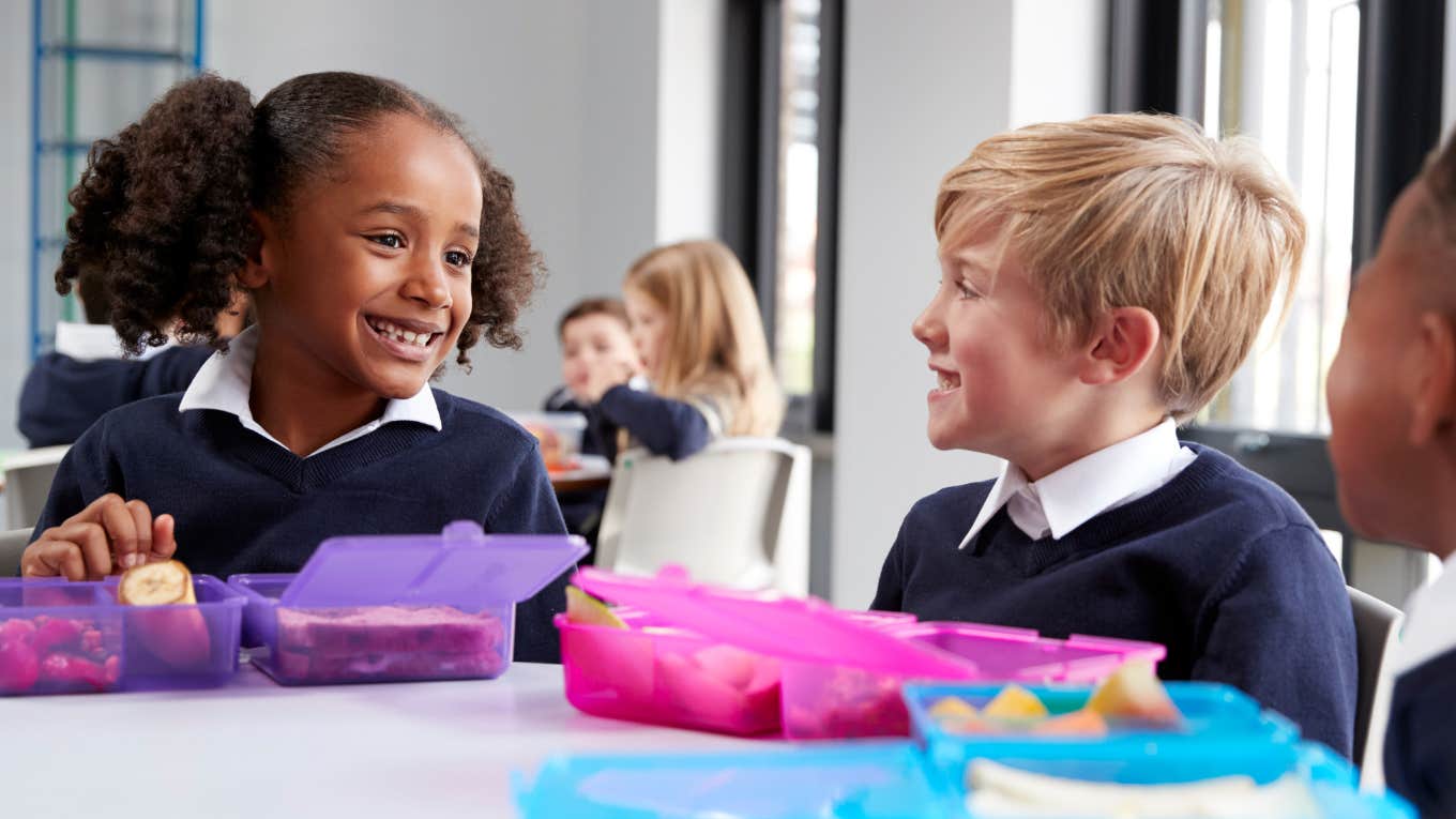 Little kids having school lunch in the cafeteria. 