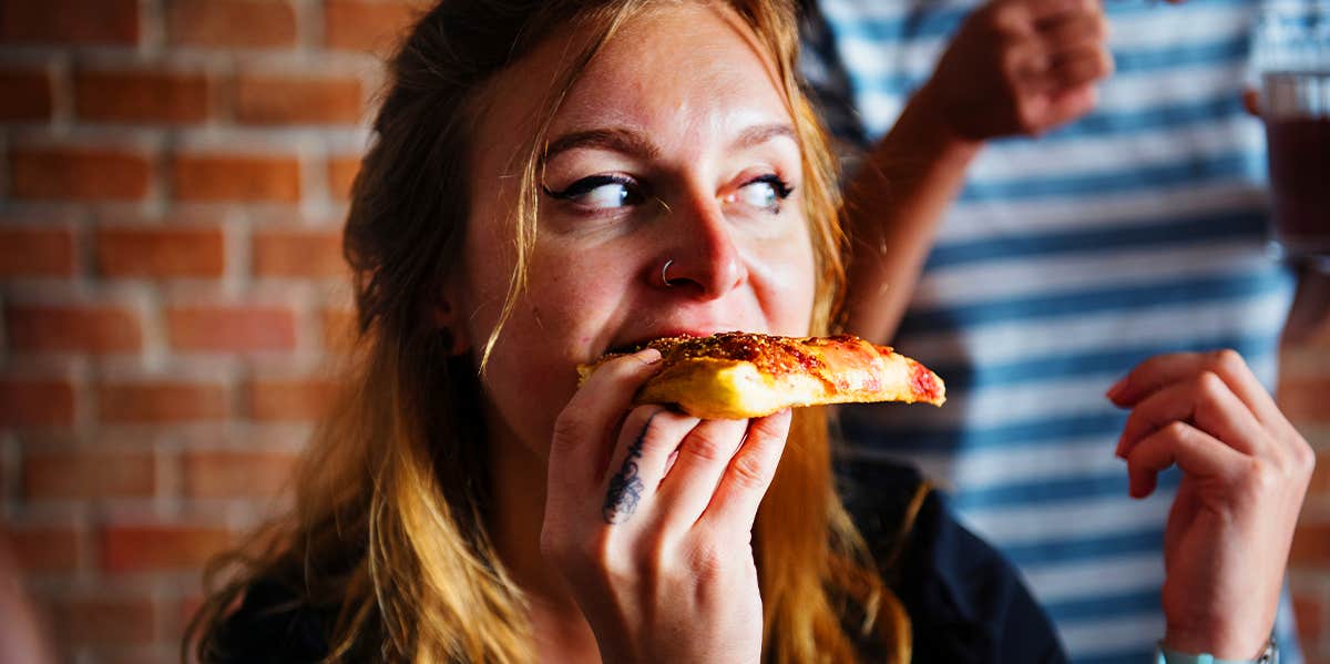 woman eating pizza