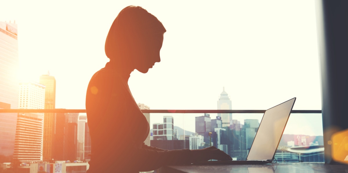 woman in shadow on laptop