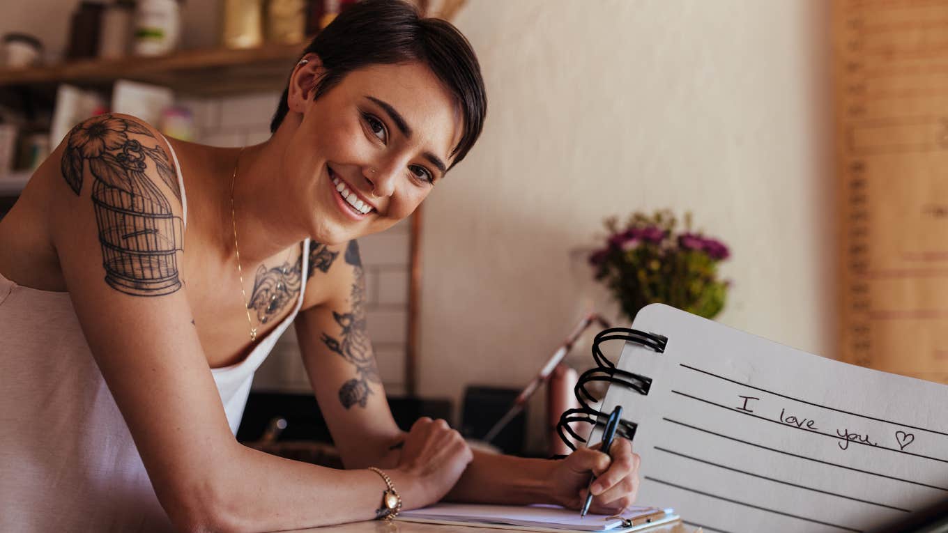 woman writing love note to show appreciation