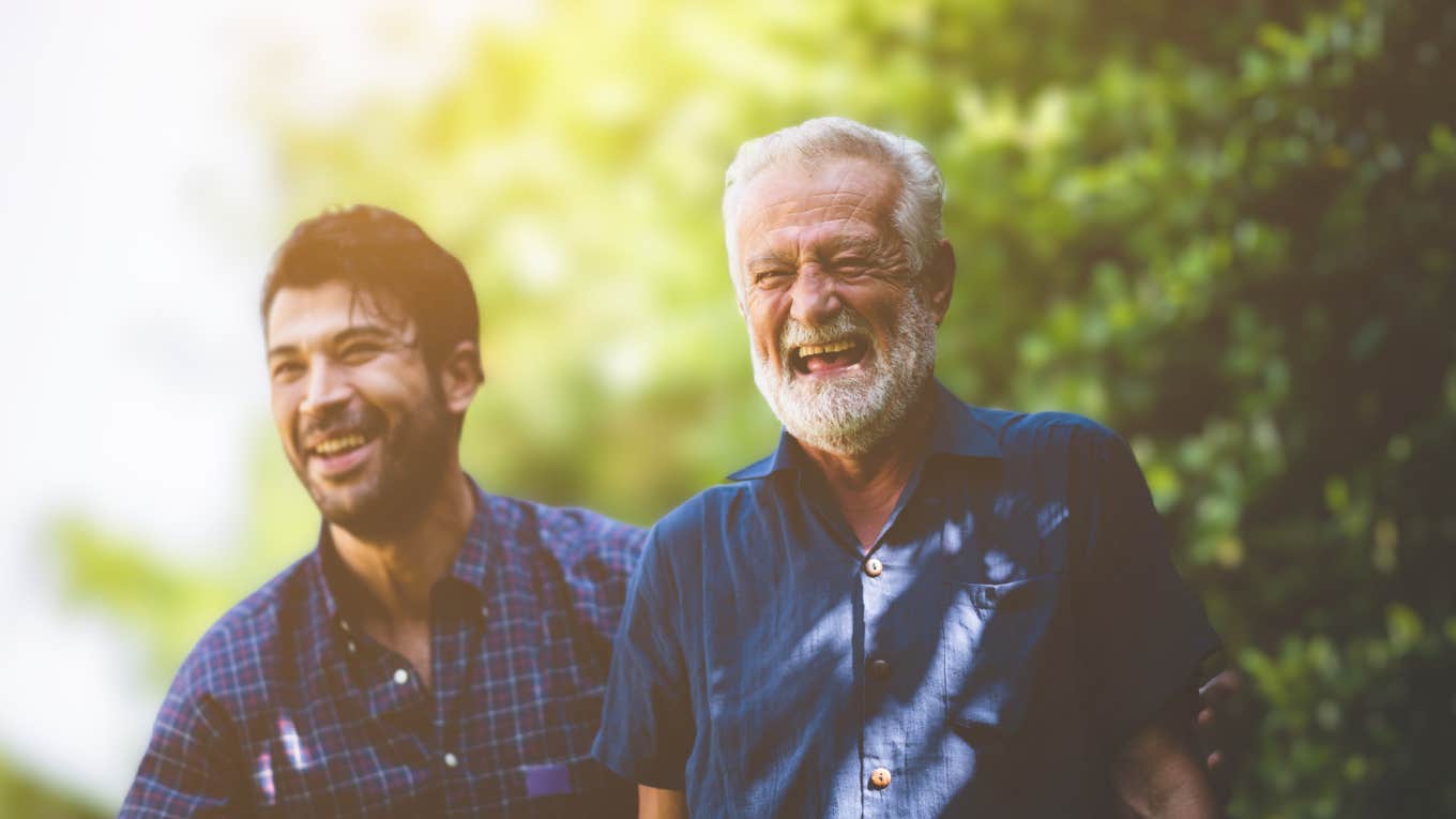 Older man laughing with his adult son