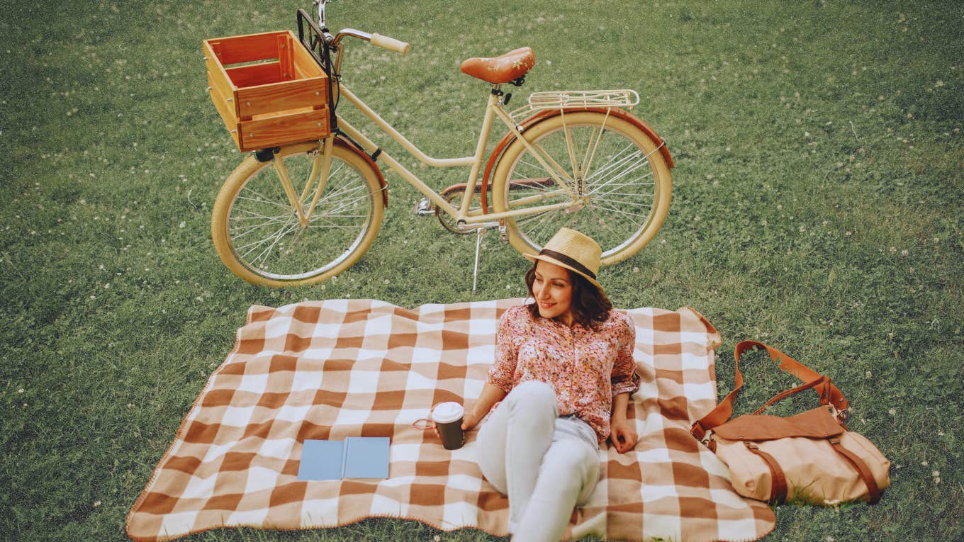 Woman spending time alone in park with a book