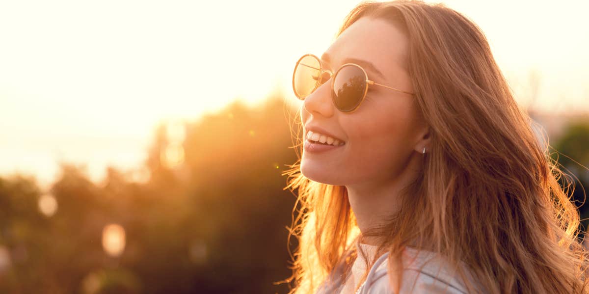 The Secret To Eternal Happiness Comes Down To This One Word smiling woman