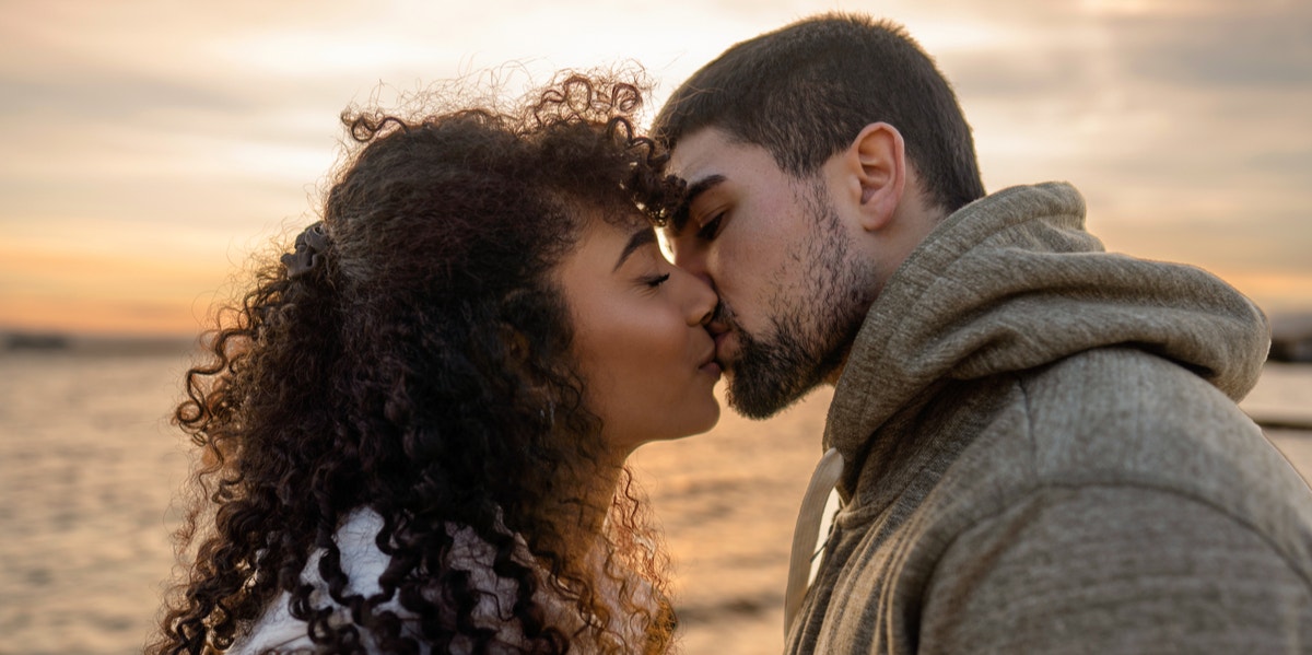 man and woman kissing