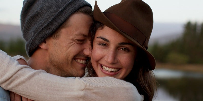 man embracing woman nose on cheek