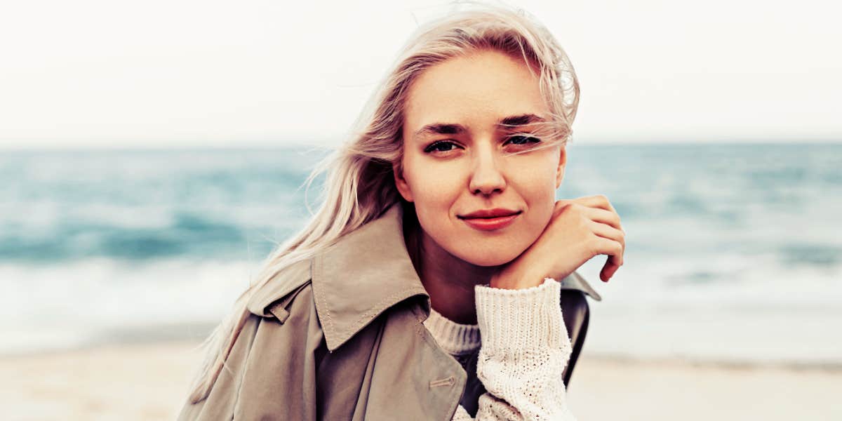 lovely young blonde woman posing on a beach