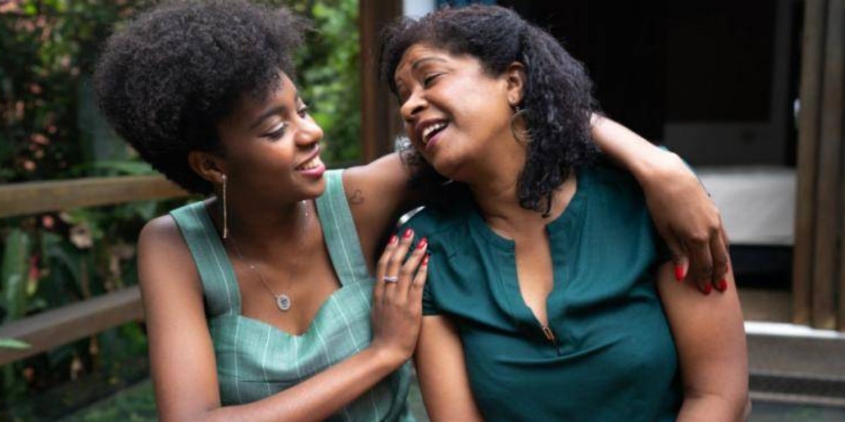 woman and adult daughter sitting and hugging