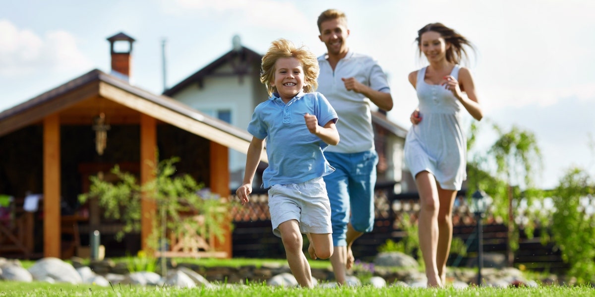 family running outside of a house