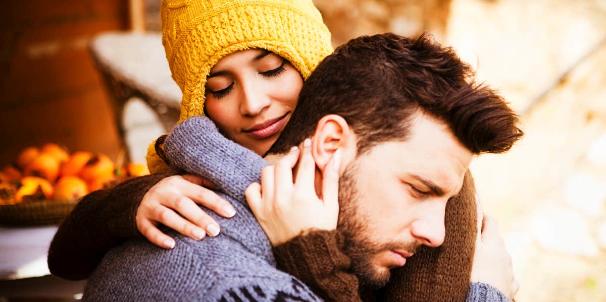 Woman comforts upset man