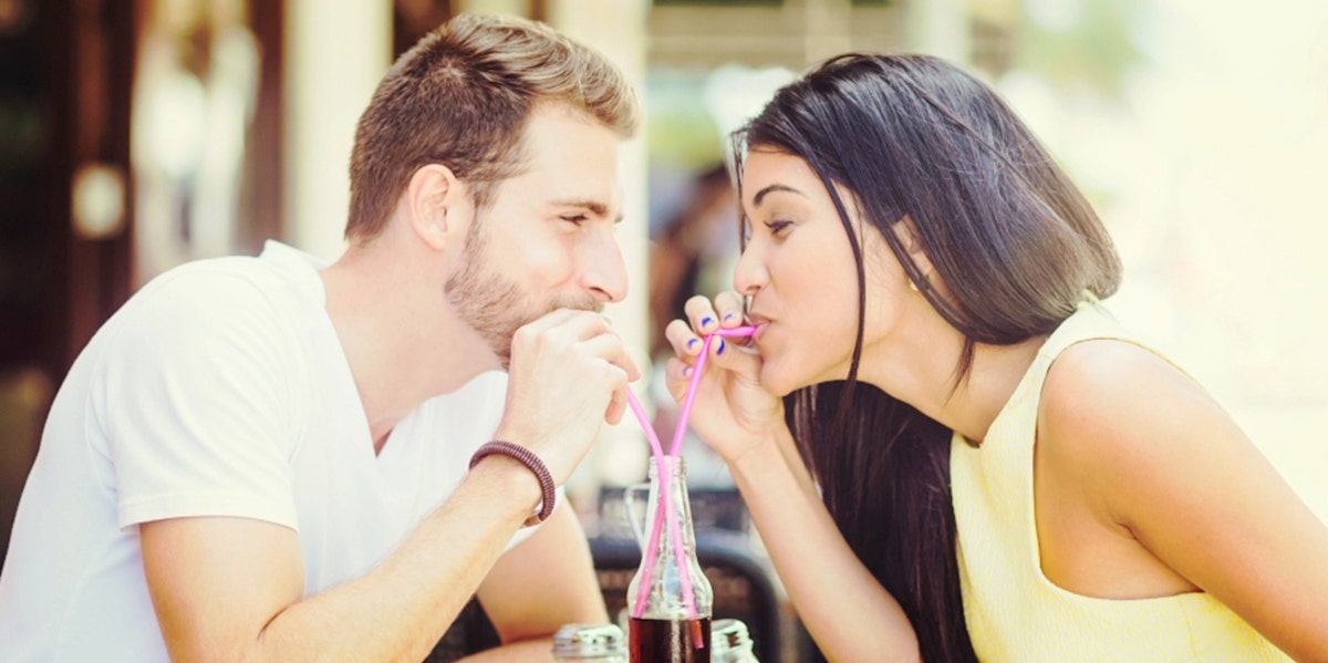 man and woman on first date sharing a straw