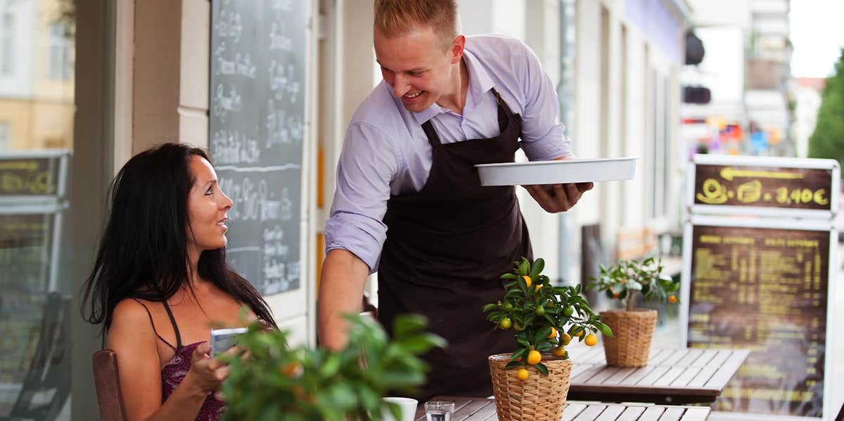 waiter serving woman