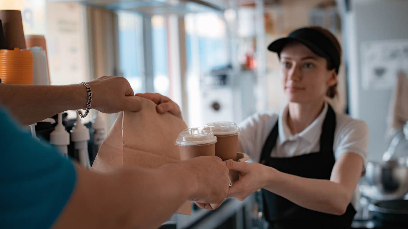 service industry worker handing customer order