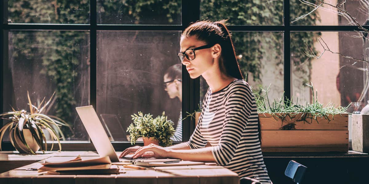 young woman sitting at desk, working