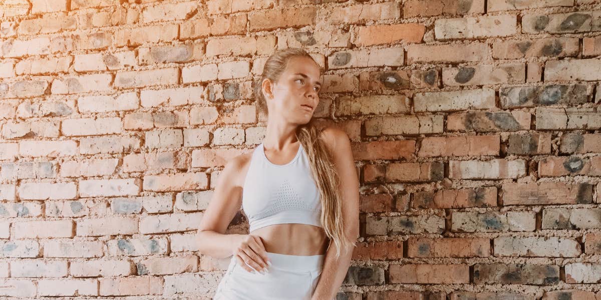 woman on brick wall