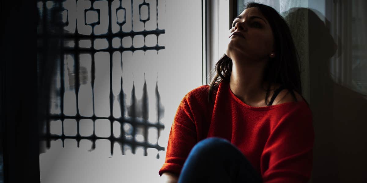 woman sitting alone in the dark