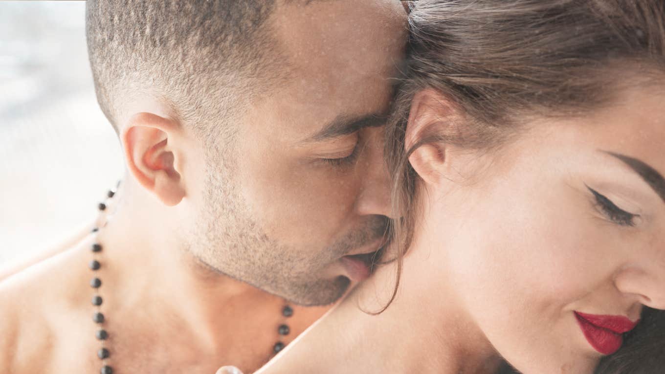 Man kissing woman’s neck 