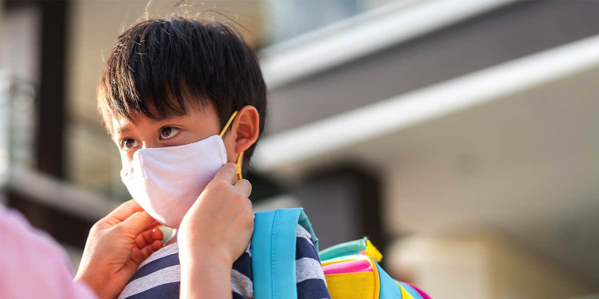 little boy wearing a mask