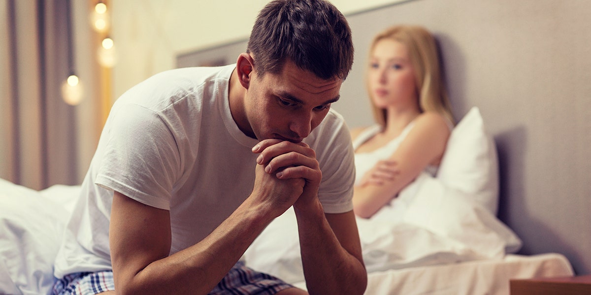 man and woman looking frustrated on bed