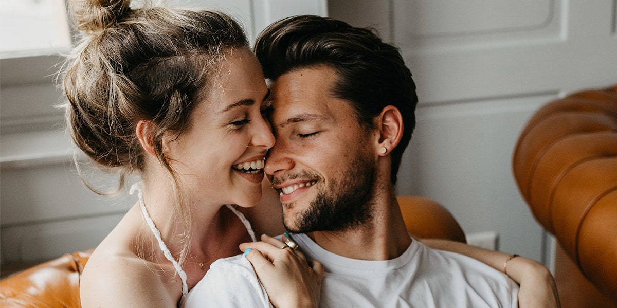 man and woman snuggling up to each other