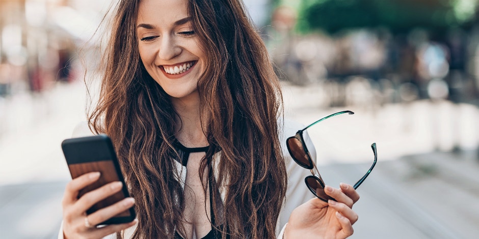 happy woman looking at her phone