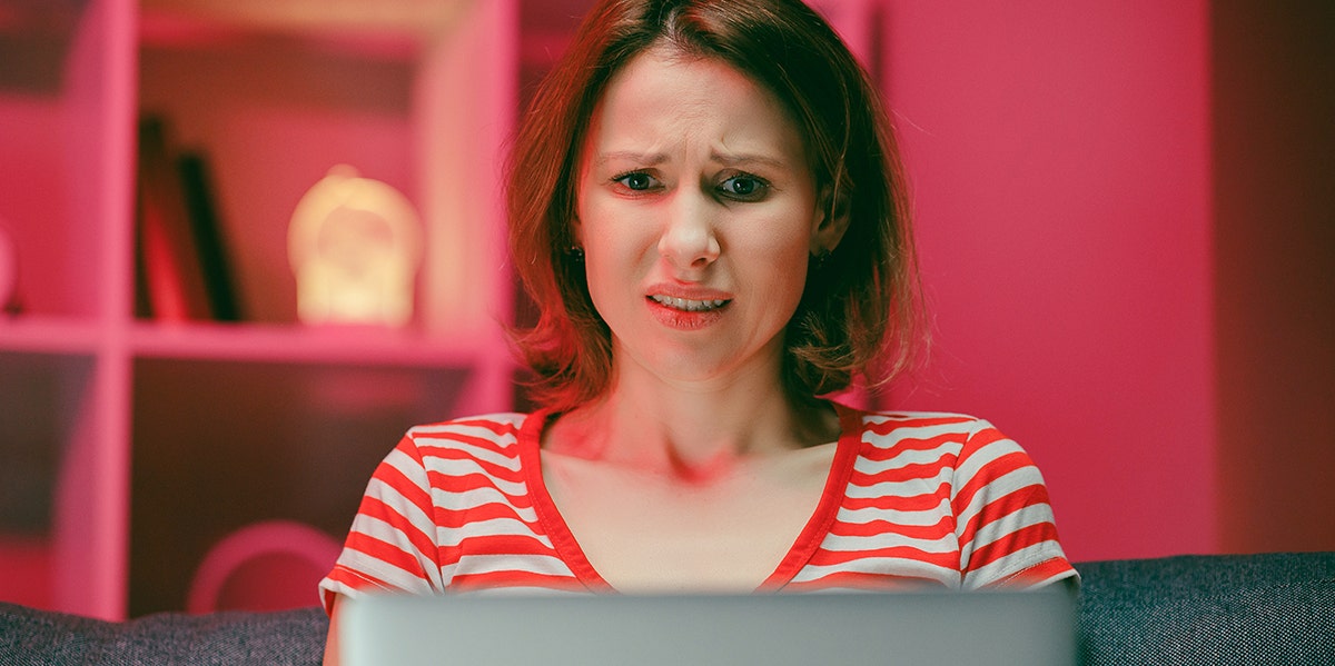 woman looking horrified at computer screen