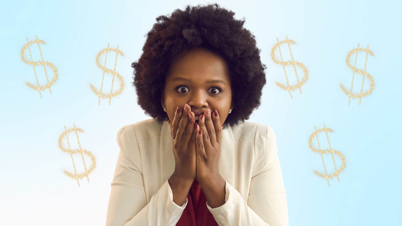 Woman looks excited in front of money signs. 