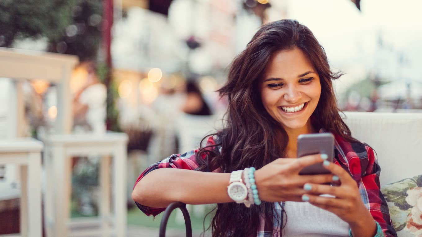 Girl smiling on her phone 