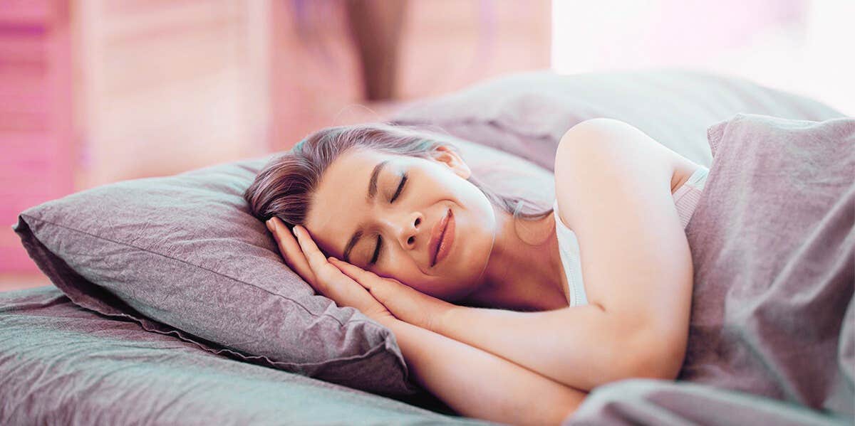woman smiling in bed sleeping