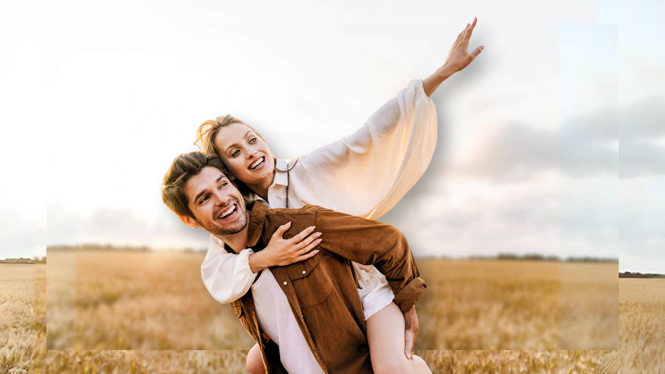 Couple being playful in the middle of a field 