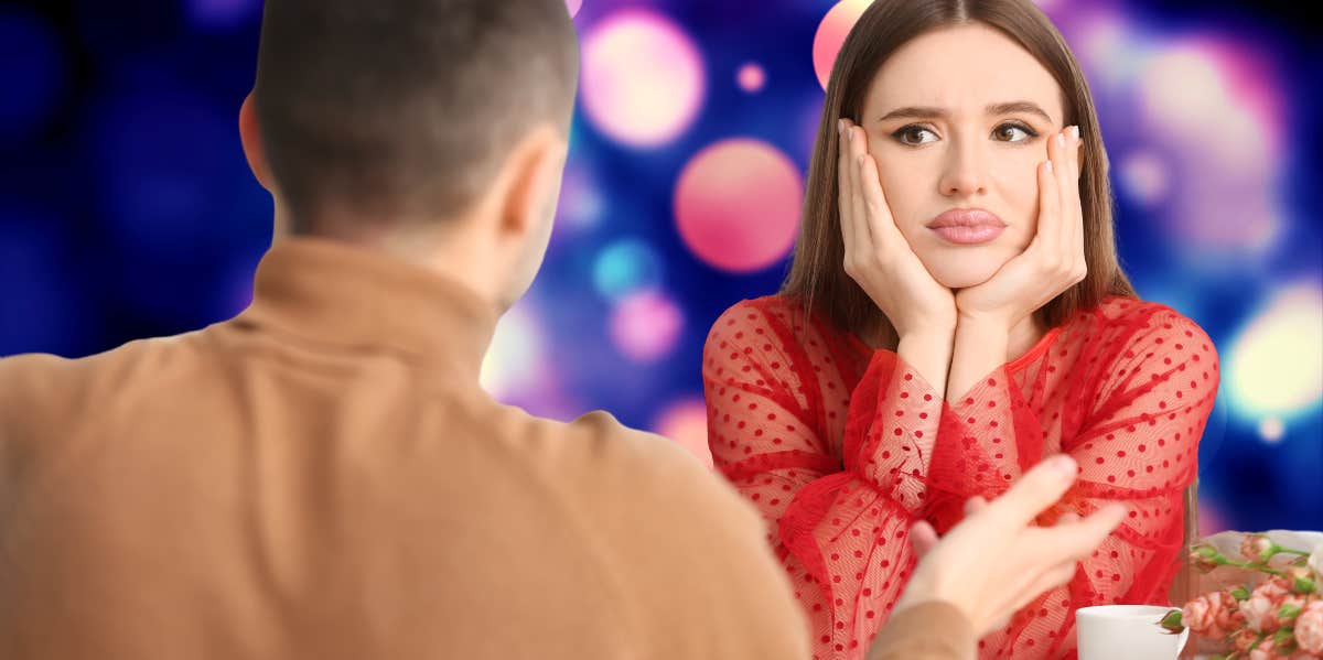 woman with chin cradled in her hands looking exasperated across the table while on a date